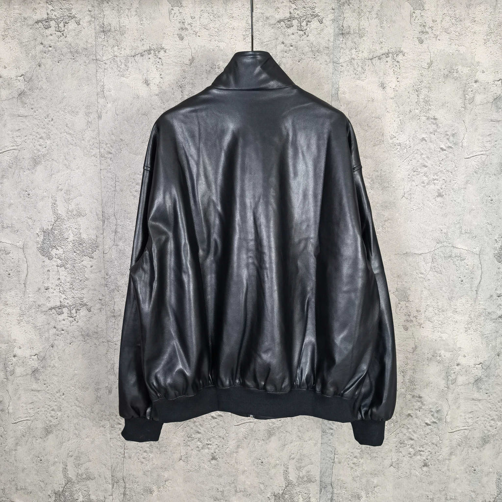 Black leather jacket back view with ribbed hem and sleeves