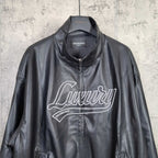 Black leather zip-up jacket with stand collar and white “Luxury” logo