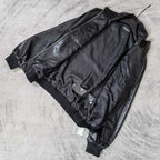Black leather jacket back view with side seams and ribbed cuffs