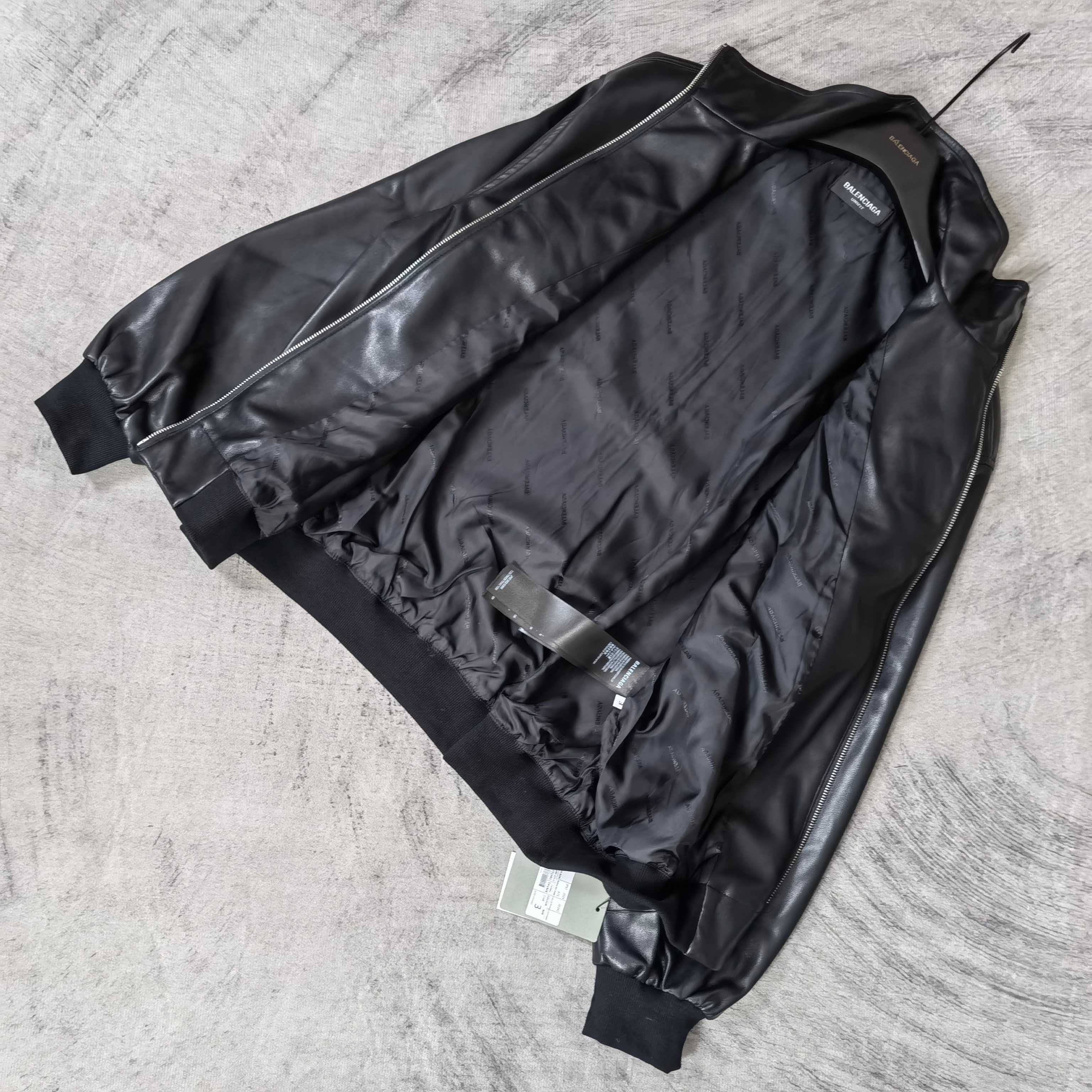 Black leather jacket back view with side seams and ribbed cuffs