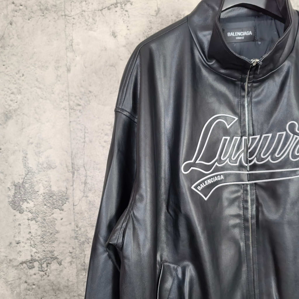 Black leather jacket front close-up of stand collar and “Luxury” graphic