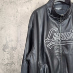 Black leather jacket front close-up of stand collar and “Luxury” graphic