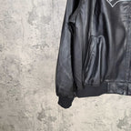 Black leather jacket sleeve and side pocket close-up with ribbed cuff