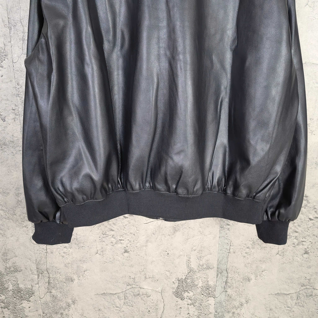 Dark leather jacket hem with ribbed waist and elastic cuffs