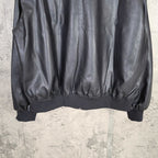 Dark leather jacket hem with ribbed waist and elastic cuffs
