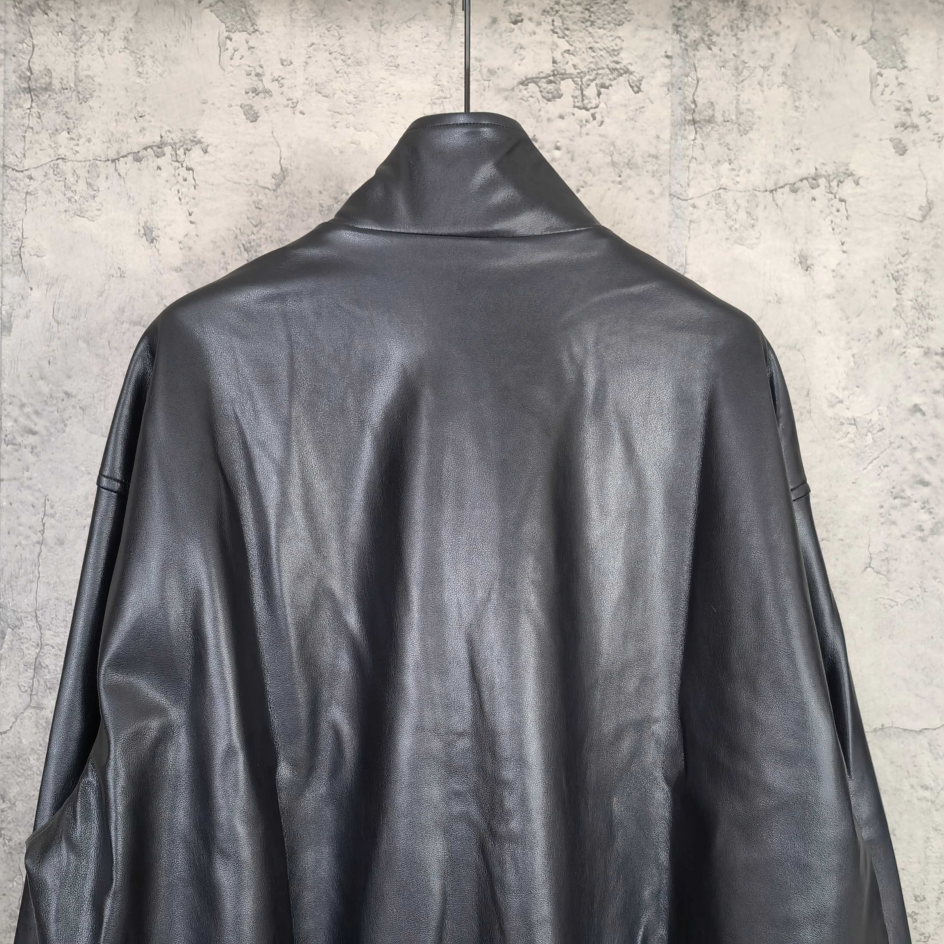 Dark leather hooded jacket, back view with stand collar and full sleeves