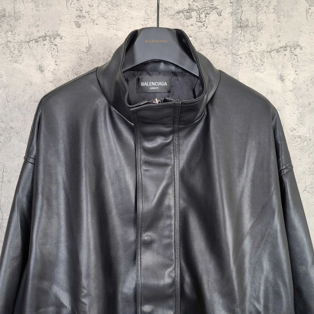 Balenciaga dark leather jacket close-up with zip front and stand collar