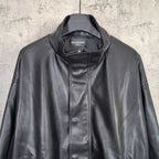 Balenciaga dark leather jacket close-up with zip front and stand collar