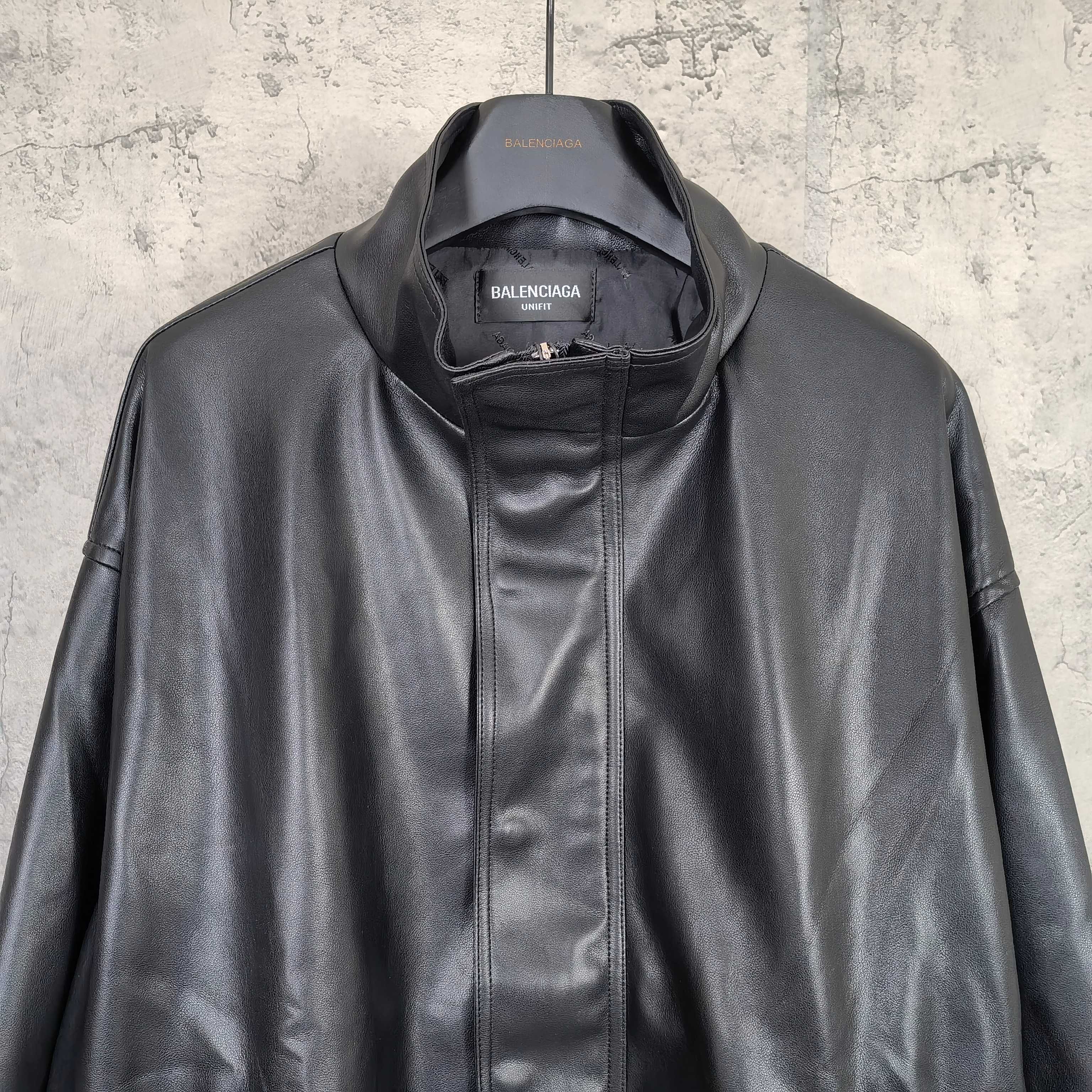 Balenciaga dark leather jacket close-up with zip front and stand collar