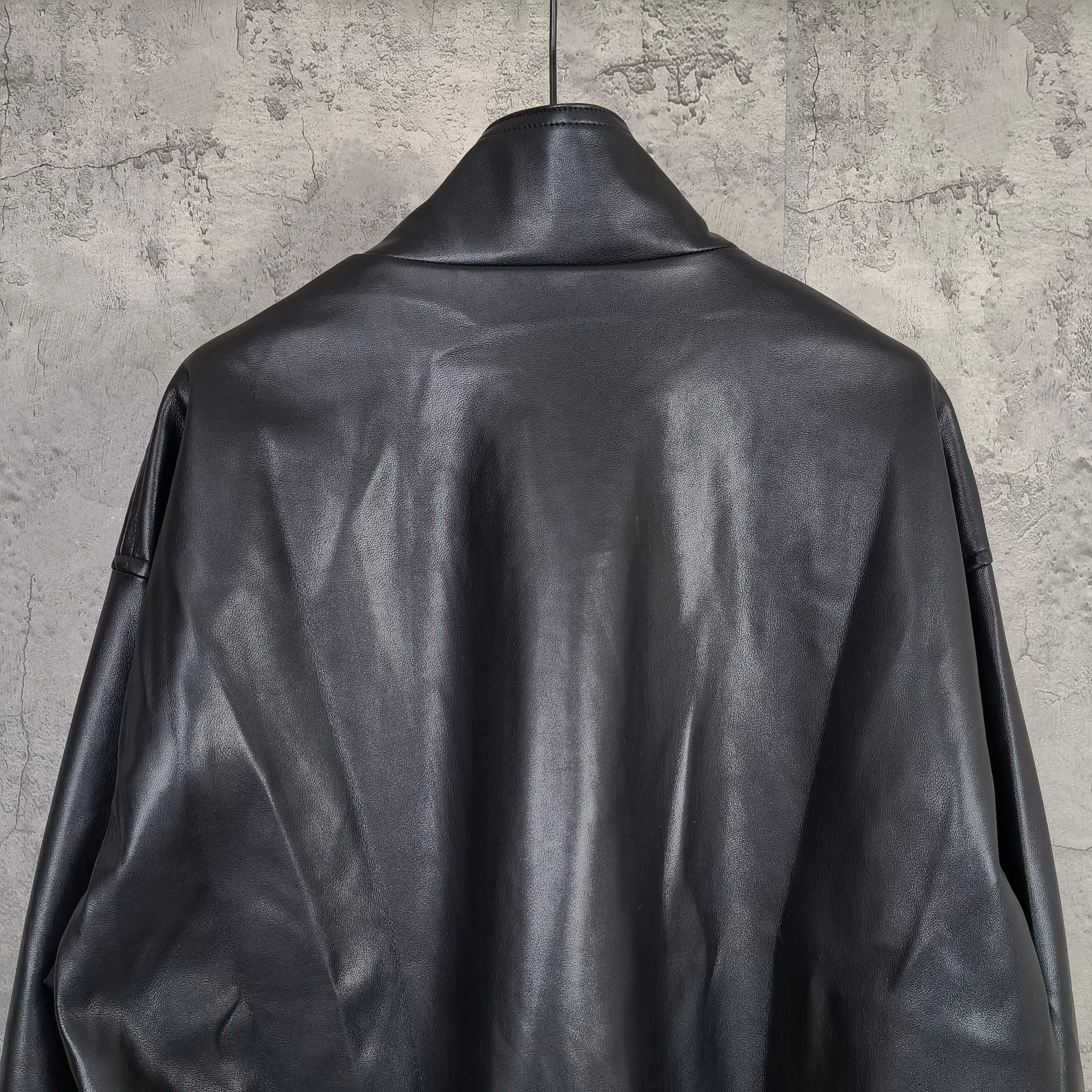 Balenciaga dark leather jacket back view with ribbed hem and sleeve details