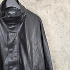 Balenciaga dark leather jacket collar and zip front, with brand label visible