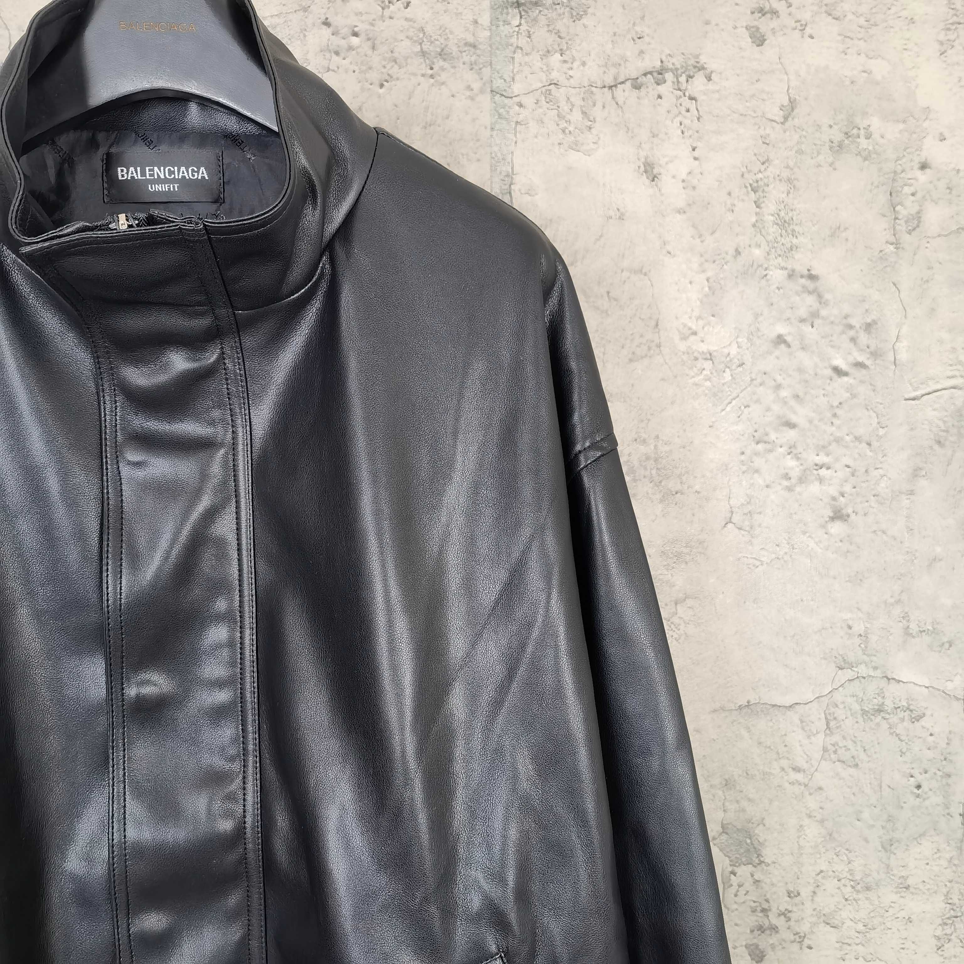 Balenciaga dark leather jacket collar and zip front, with brand label visible