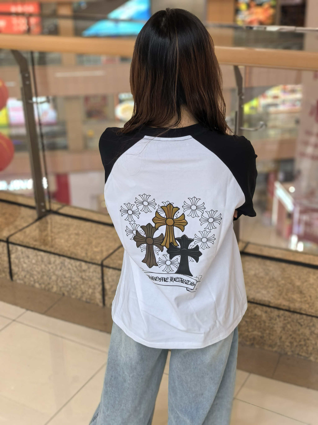 Long-sleeve raglan T-shirt on model, back print cross with flowers and ribbon text