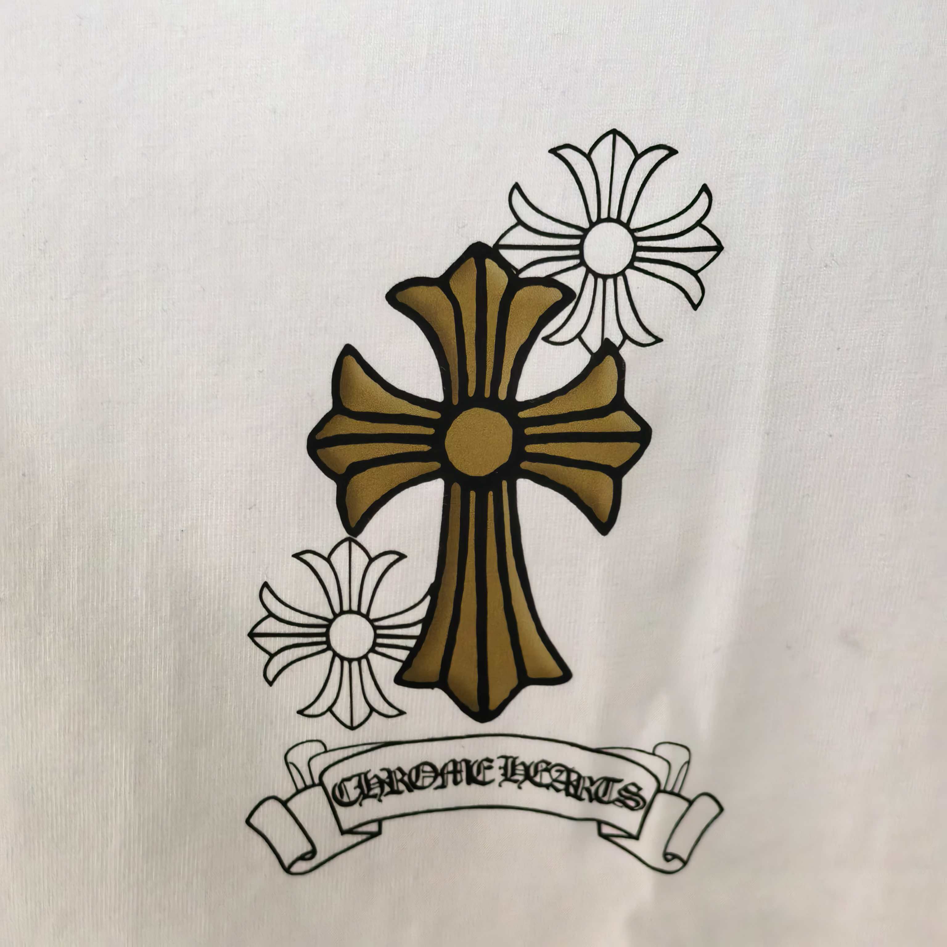 Cross and flower emblem graphic on white long-sleeve T-shirt