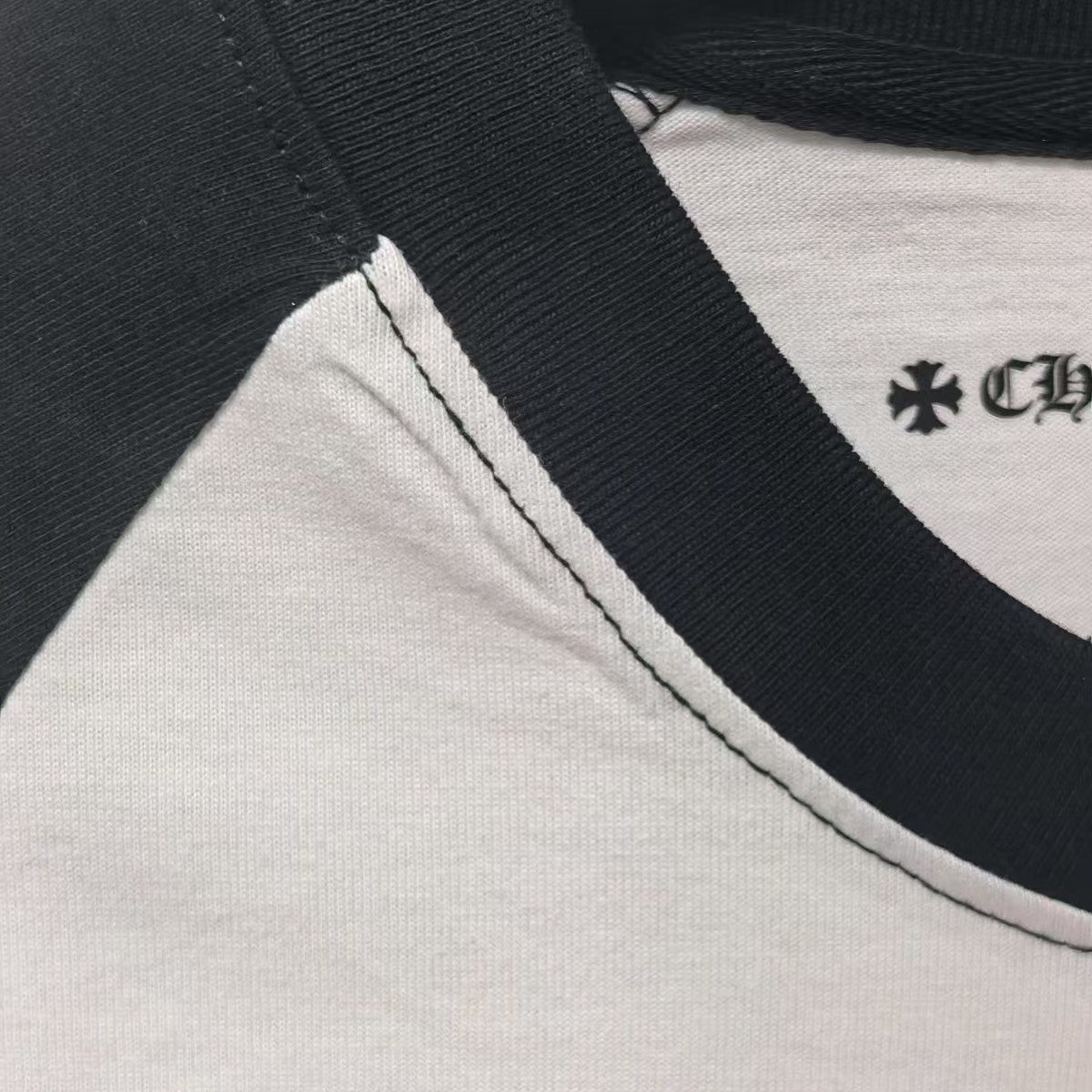 Baseball T-shirt neckline close-up with black trim and contrast white topstitching