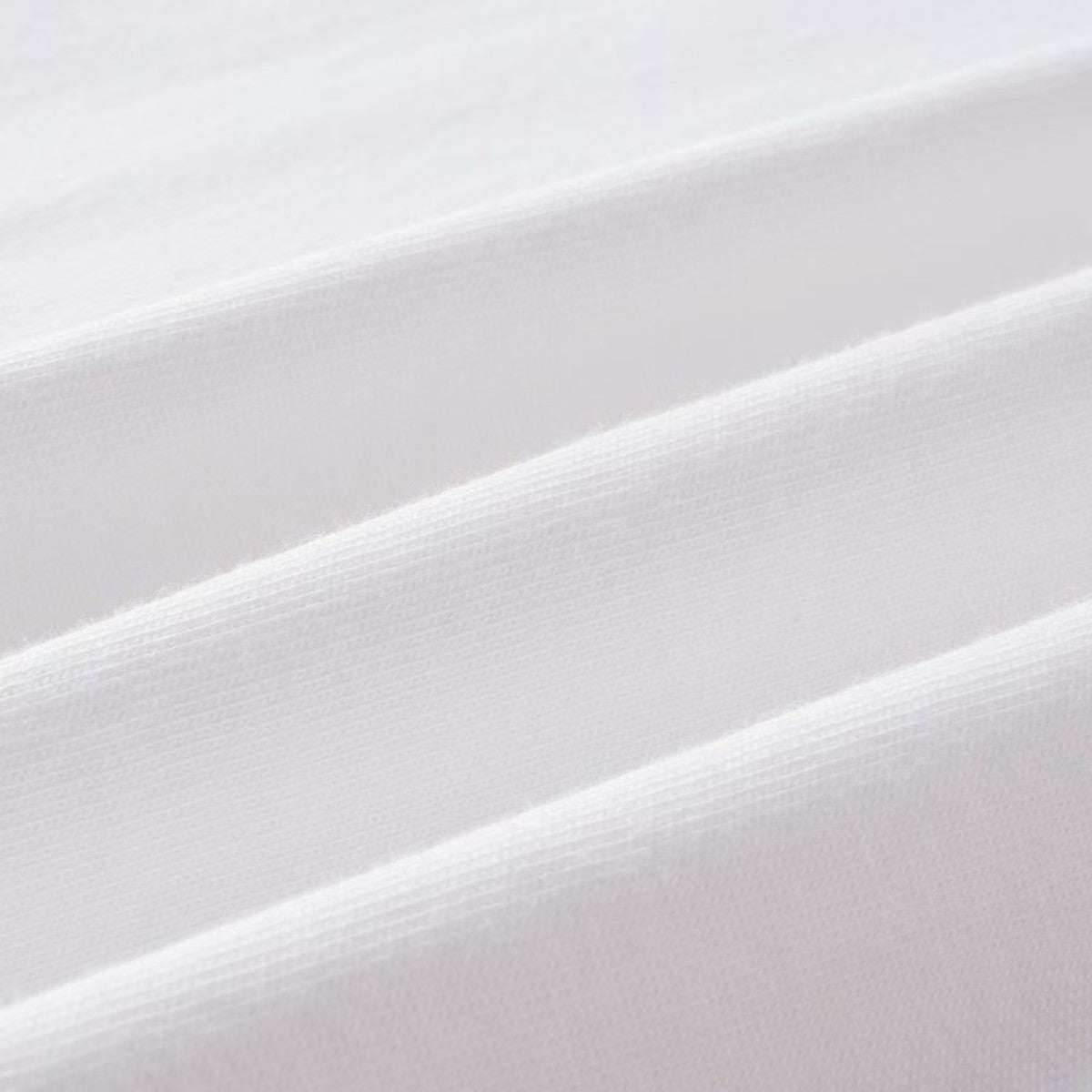 White raglan shirt fabric close-up with fine woven texture
