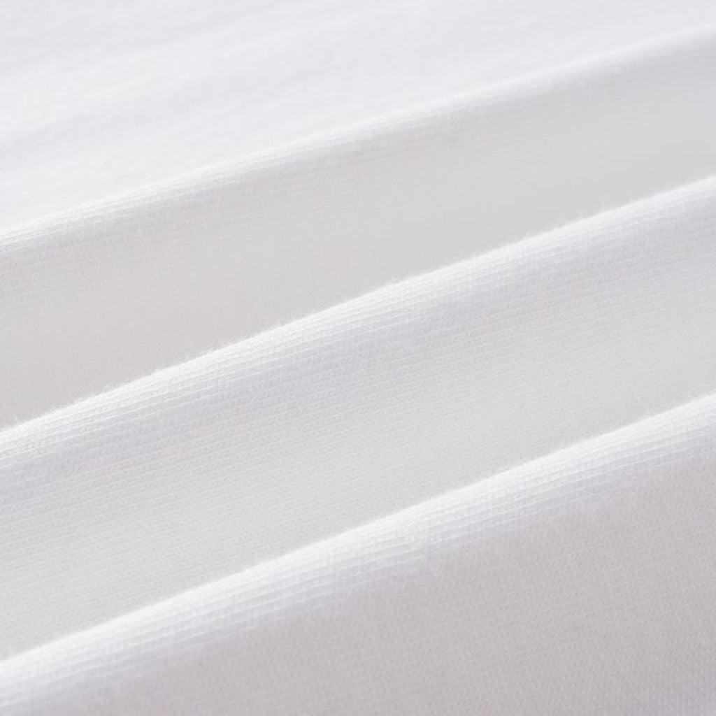 White long-sleeve shirt fabric close-up, smooth woven texture at fold
