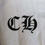 Close-up of white T-shirt chest logo, black gothic letterform graphic