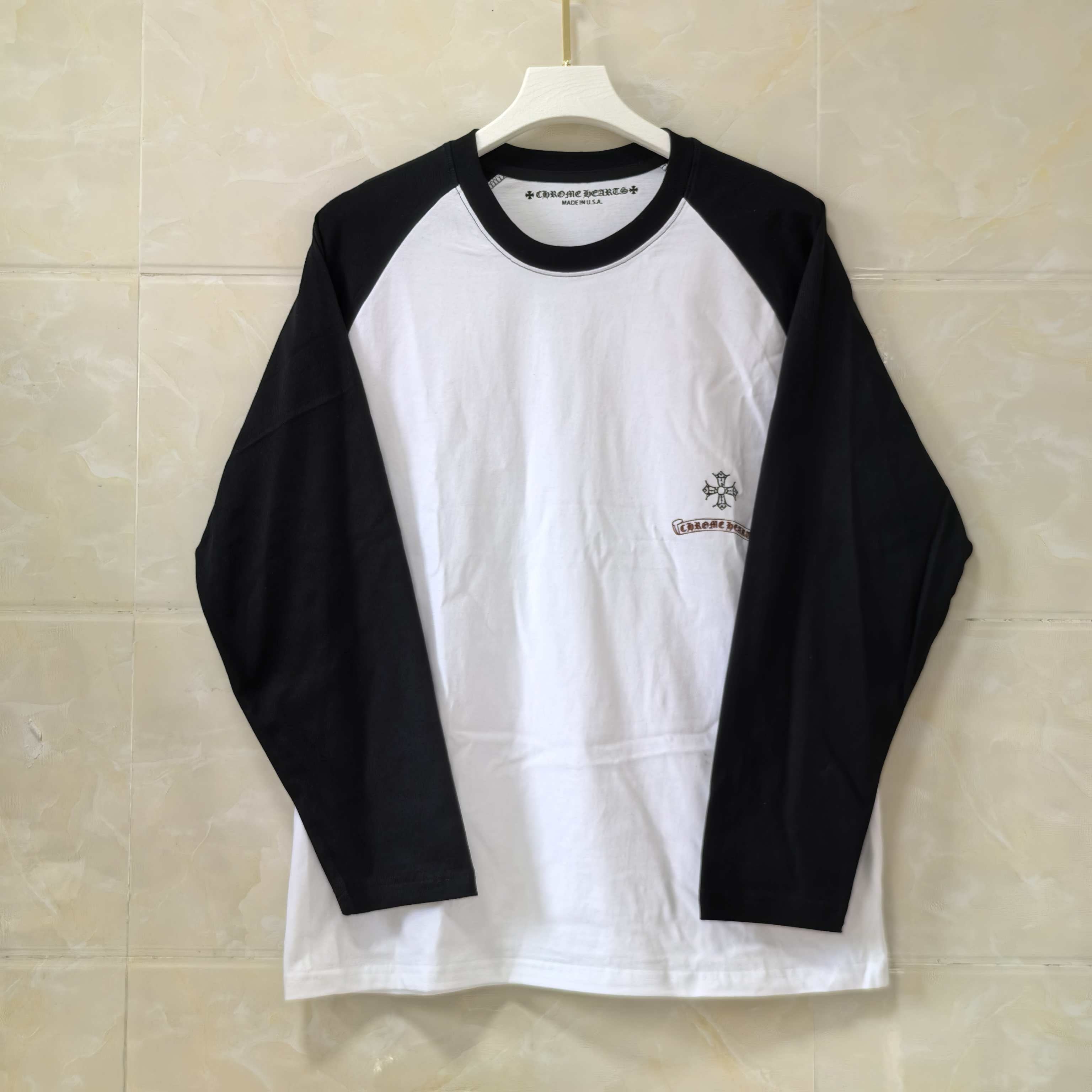 Raglan long-sleeve T-shirt, white front with black sleeves and small chest emblem