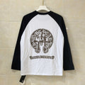 Black-and-white long-sleeve raglan shirt with round neck and front crest graphic