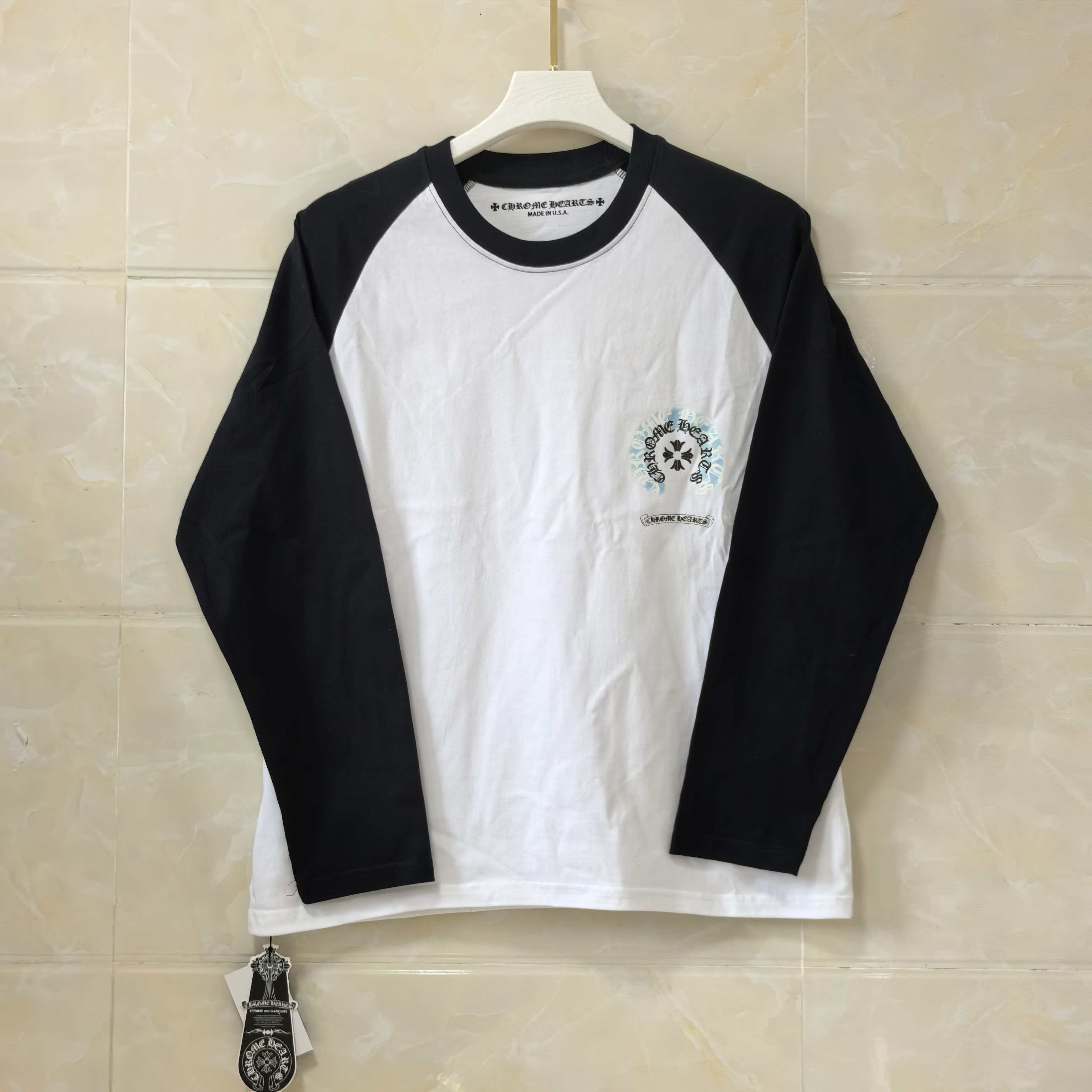 Long-sleeve raglan shirt with black sleeves, white body, small chest logo print
