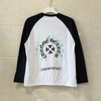Long-sleeve raglan shirt with black sleeves and white body, front graphic print