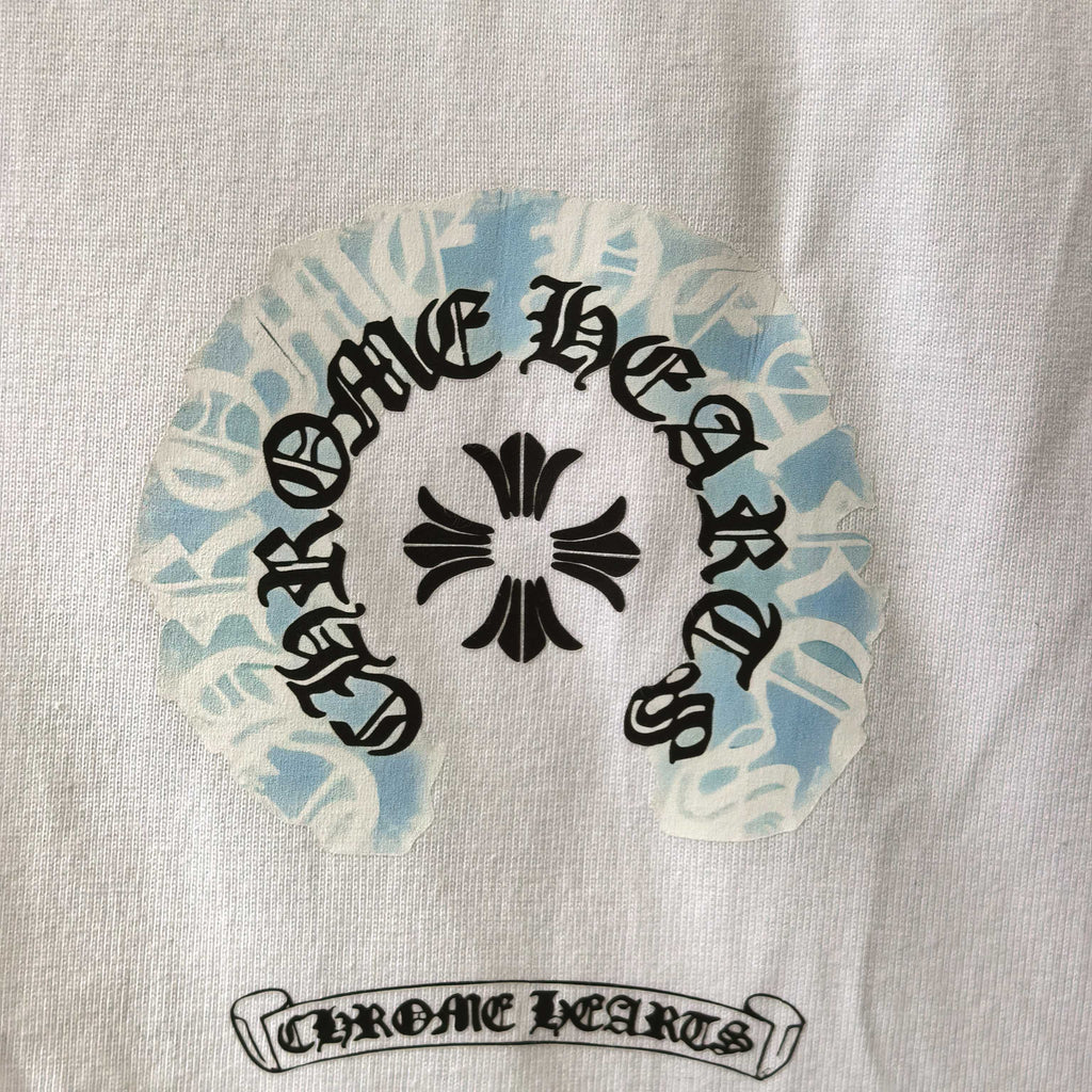 Close-up of round graphic and text print on white long-sleeve shirt