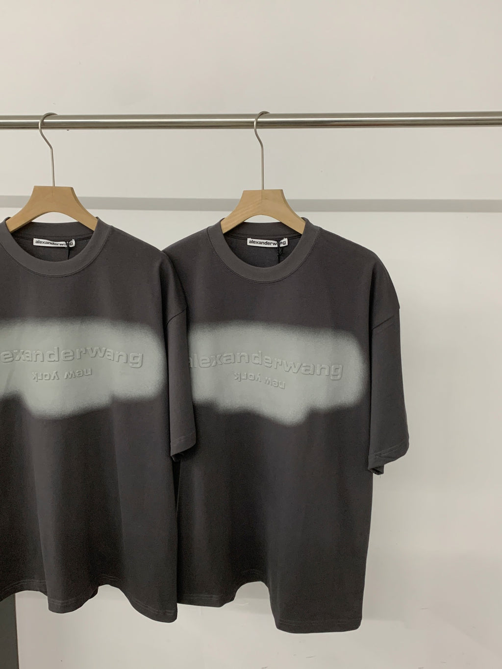 Black short-sleeve T-shirt with crew neck and centered logo graphic