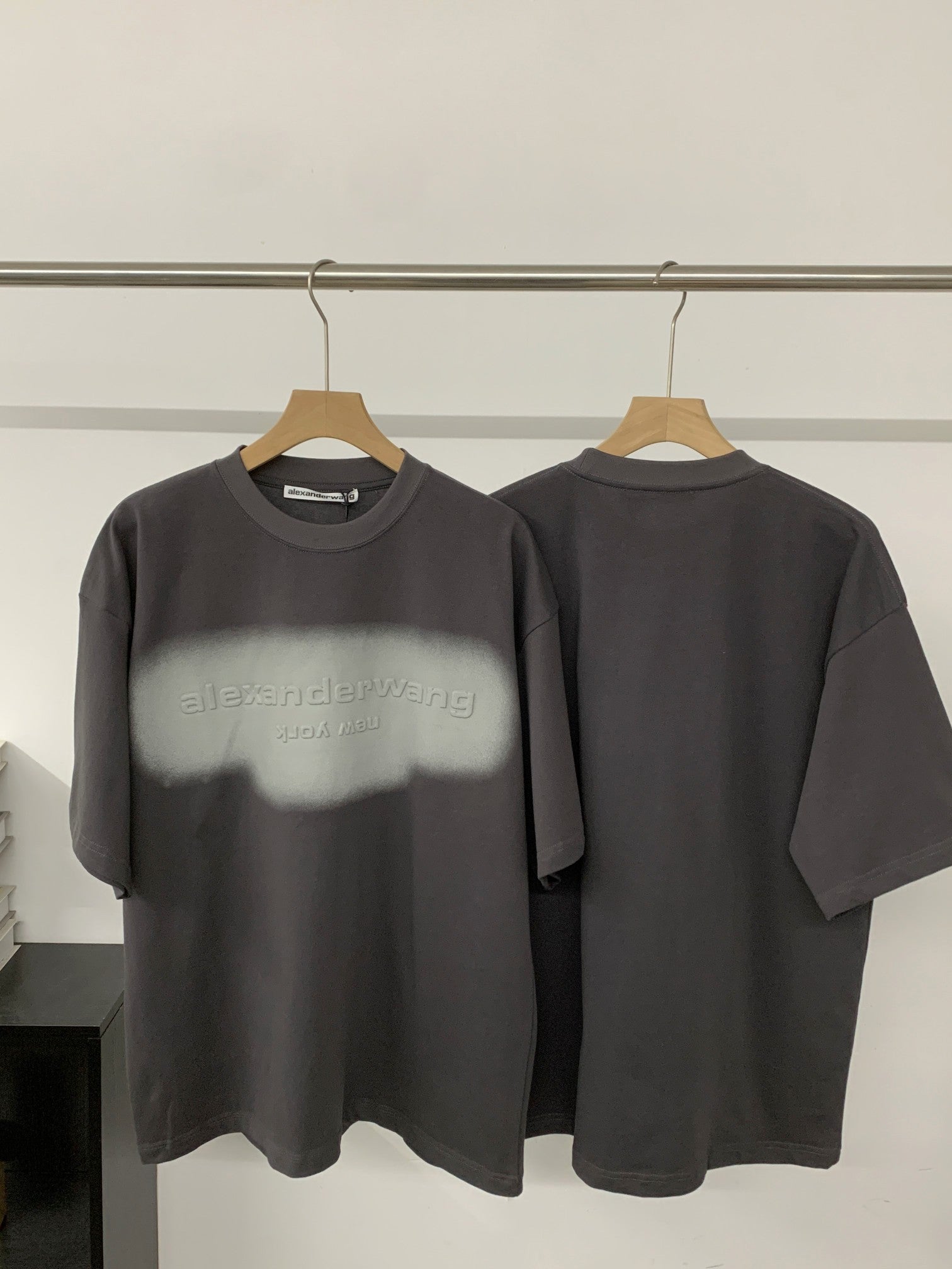 Black short-sleeve T-shirt with crew neck and front logo graphic on chest