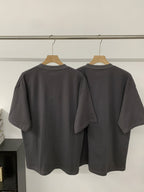 Black short-sleeve T-shirt, back view with crew neck and smooth hem