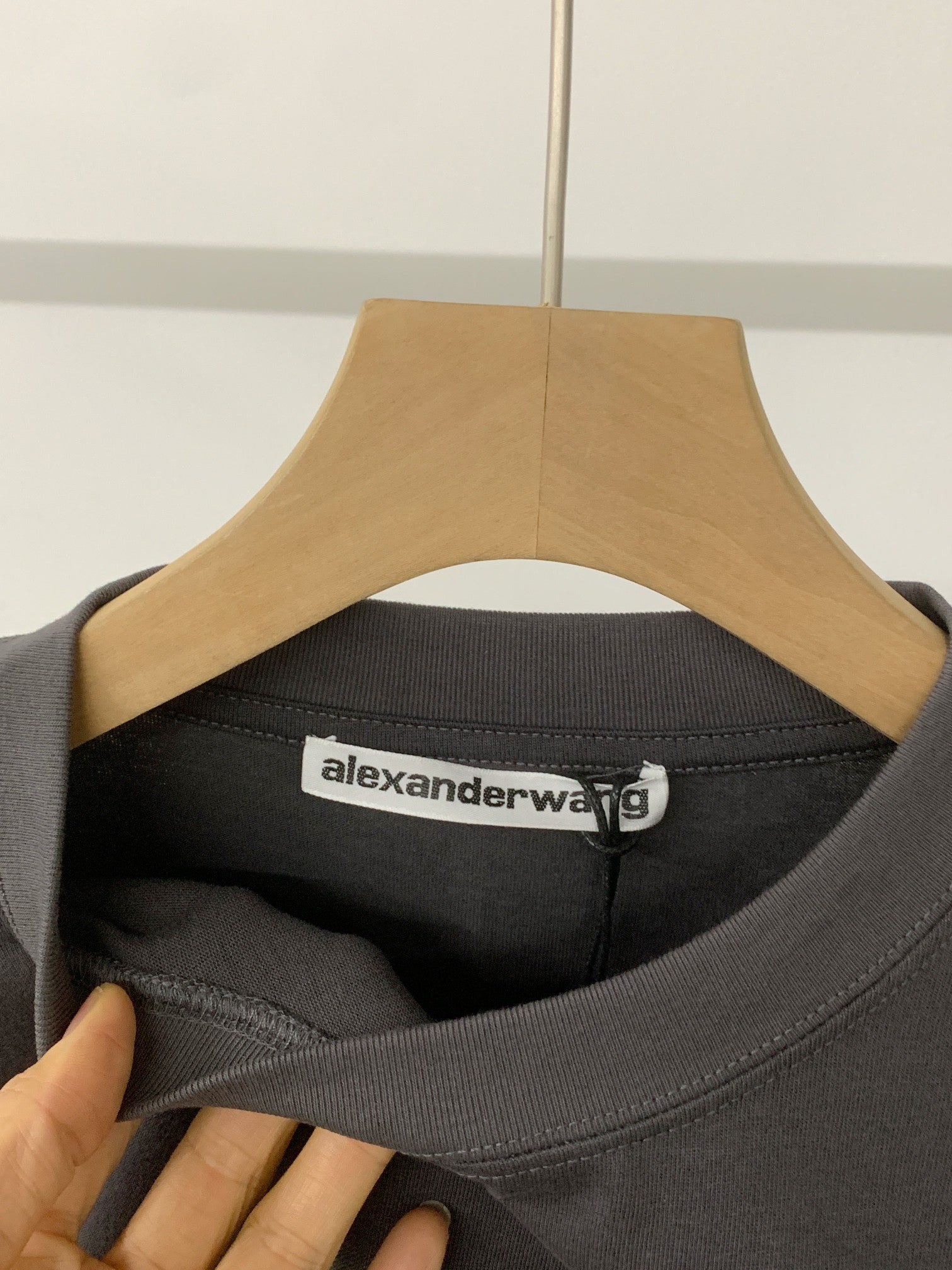 Black crew-neck T-shirt collar with alexanderwang label inside neckline