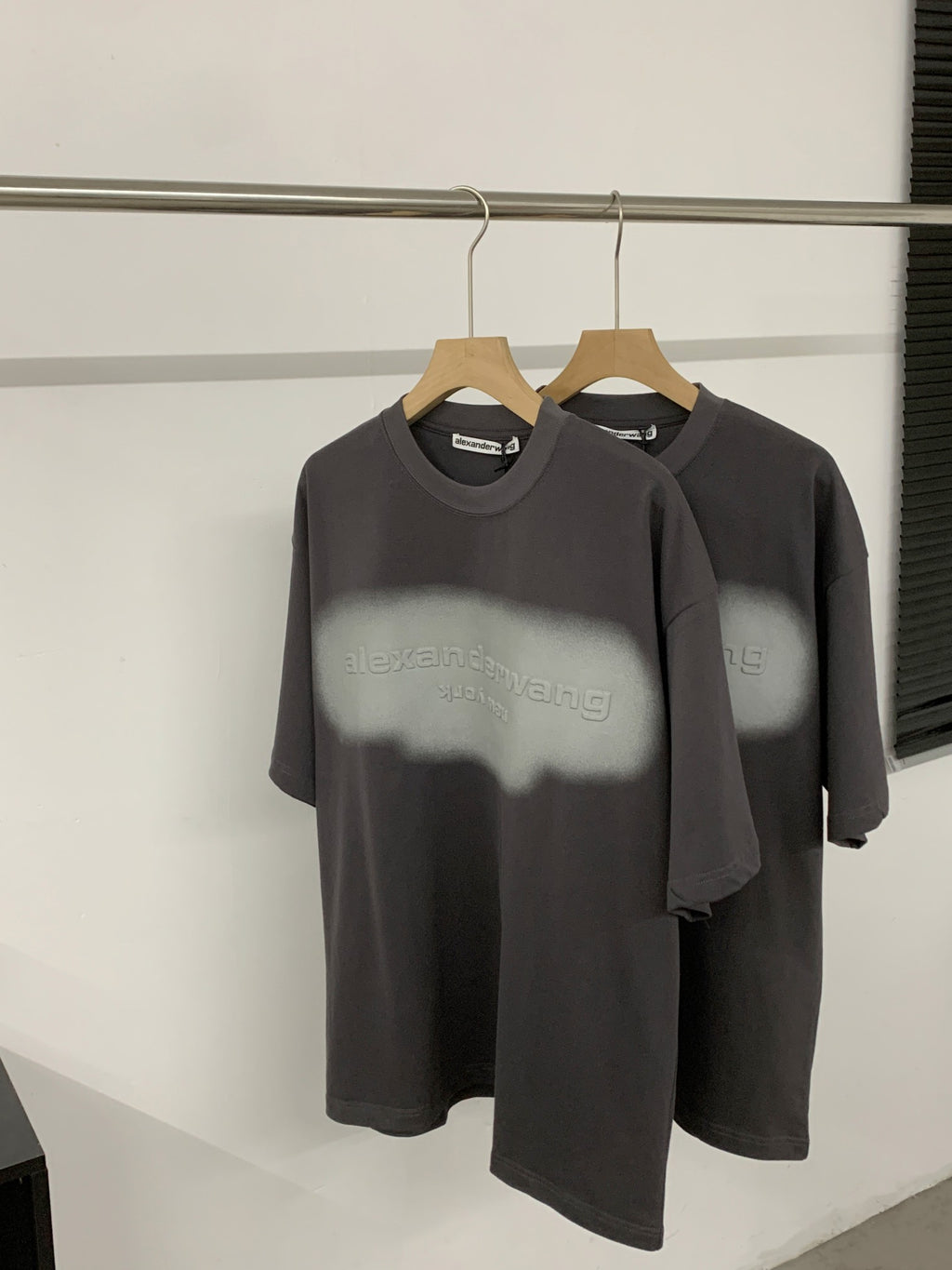 Black short-sleeve T-shirt with crew neck and centered logo graphic on front