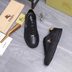 Black Burberry lace-up sneakers with horse logo on the tongue and side emblem.