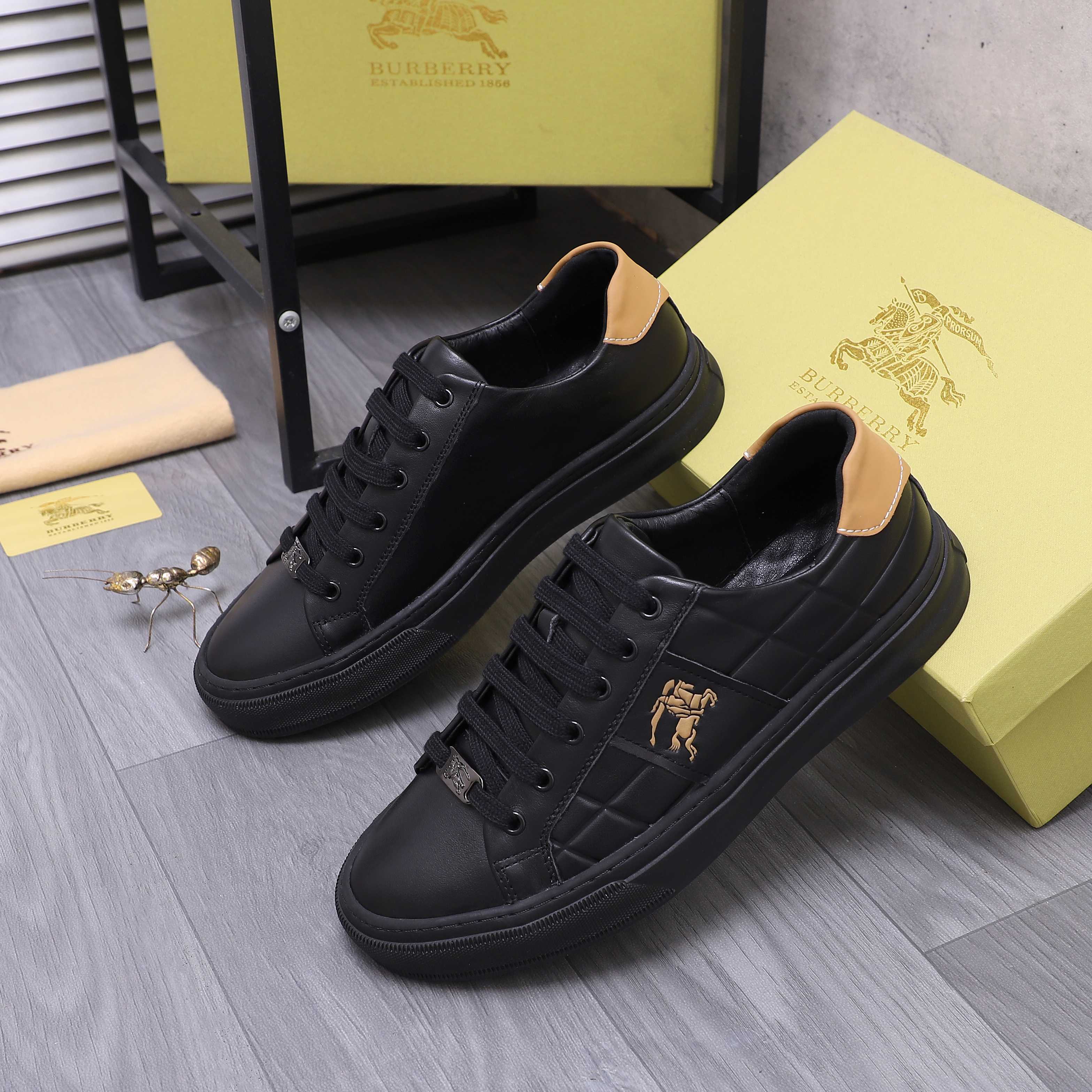 Black Burberry lace-up sneakers with quilted side panels and horse emblem.