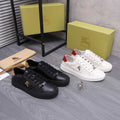 Black and white Burberry lace-up sneakers with horse emblems and tan heel trim.