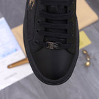 Black Burberry lace-up sneaker close-up with metal horse emblem detail.