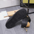 Black Burberry sneakers showing textured sole, tan heel tabs, and side horse emblem.
