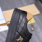 Black Burberry sneaker side view with quilted leather, tan collar, and horse emblem.