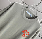 Gray crewneck T-shirt neckline with inner label and circular chest logo