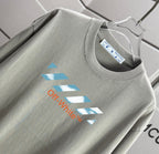 Off-White logo T-shirt close-up at neckline and front print on light gray fabric
