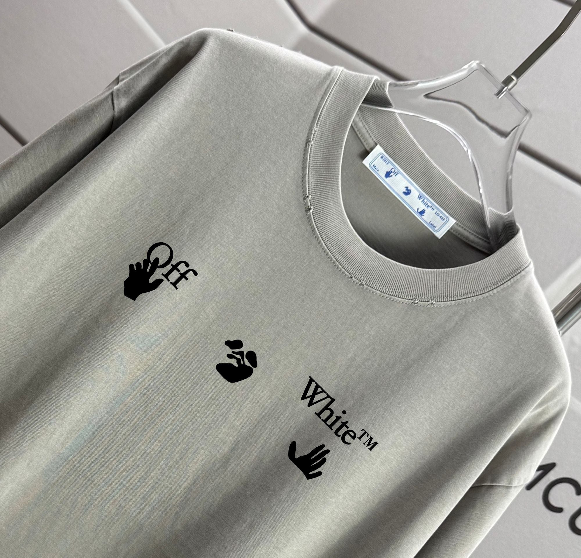 Light gray crewneck T-shirt neckline with logo prints and tag