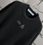 Black T-shirt neckline with small chest text and icon