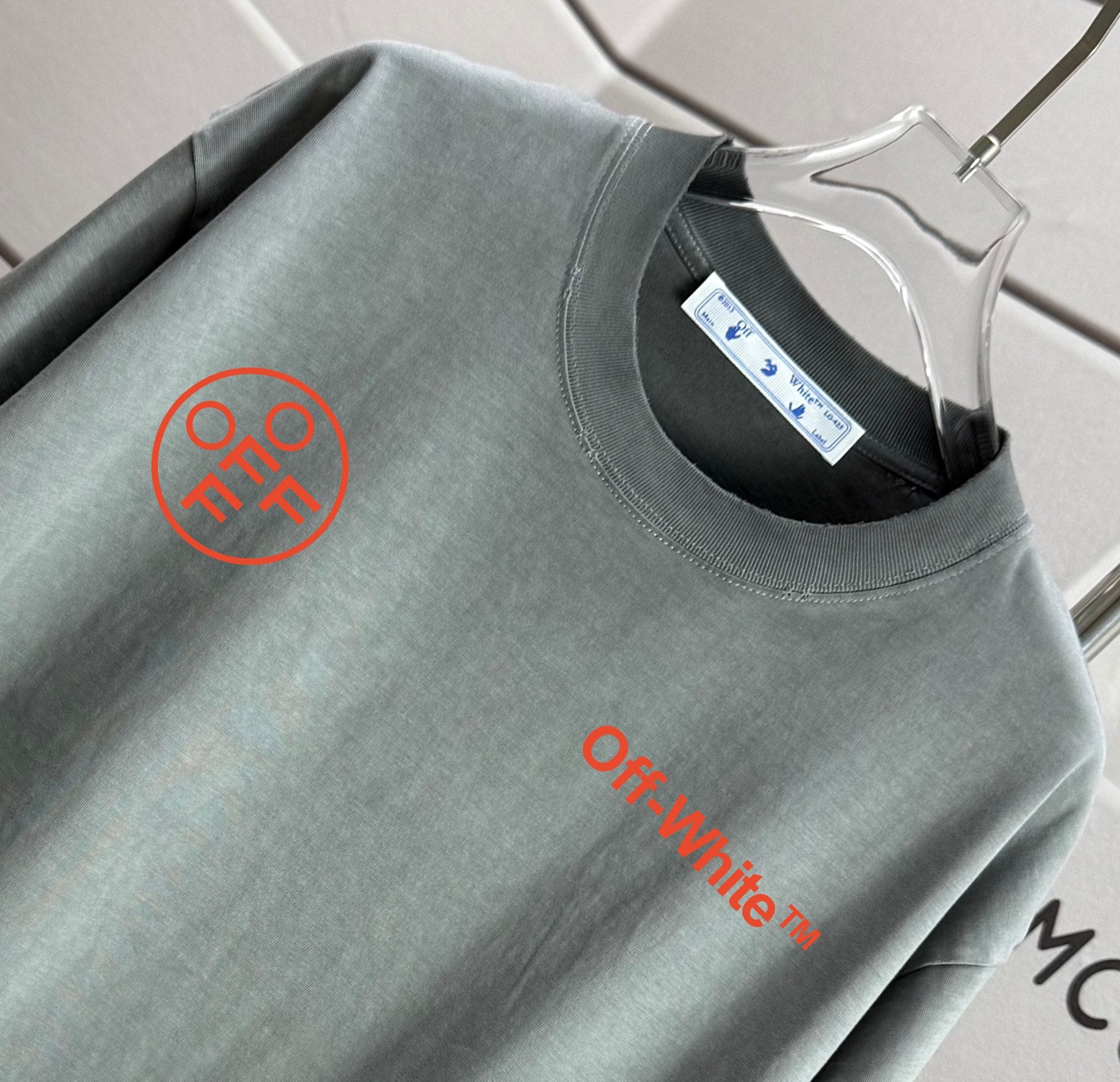 Gray T-shirt neckline with embroidered Off-White logo and red text