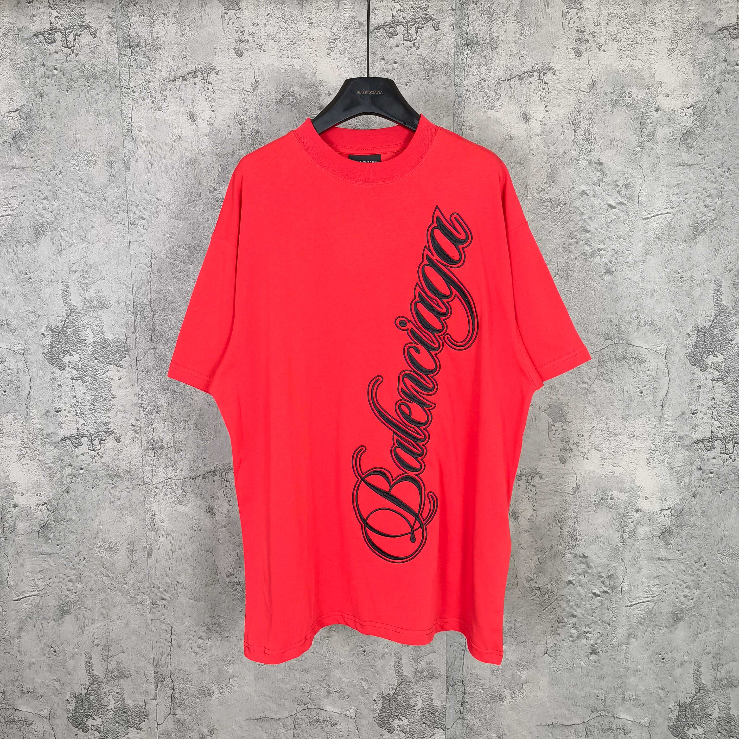 Balenciaga red short-sleeve T-shirt with black script graphic on the front