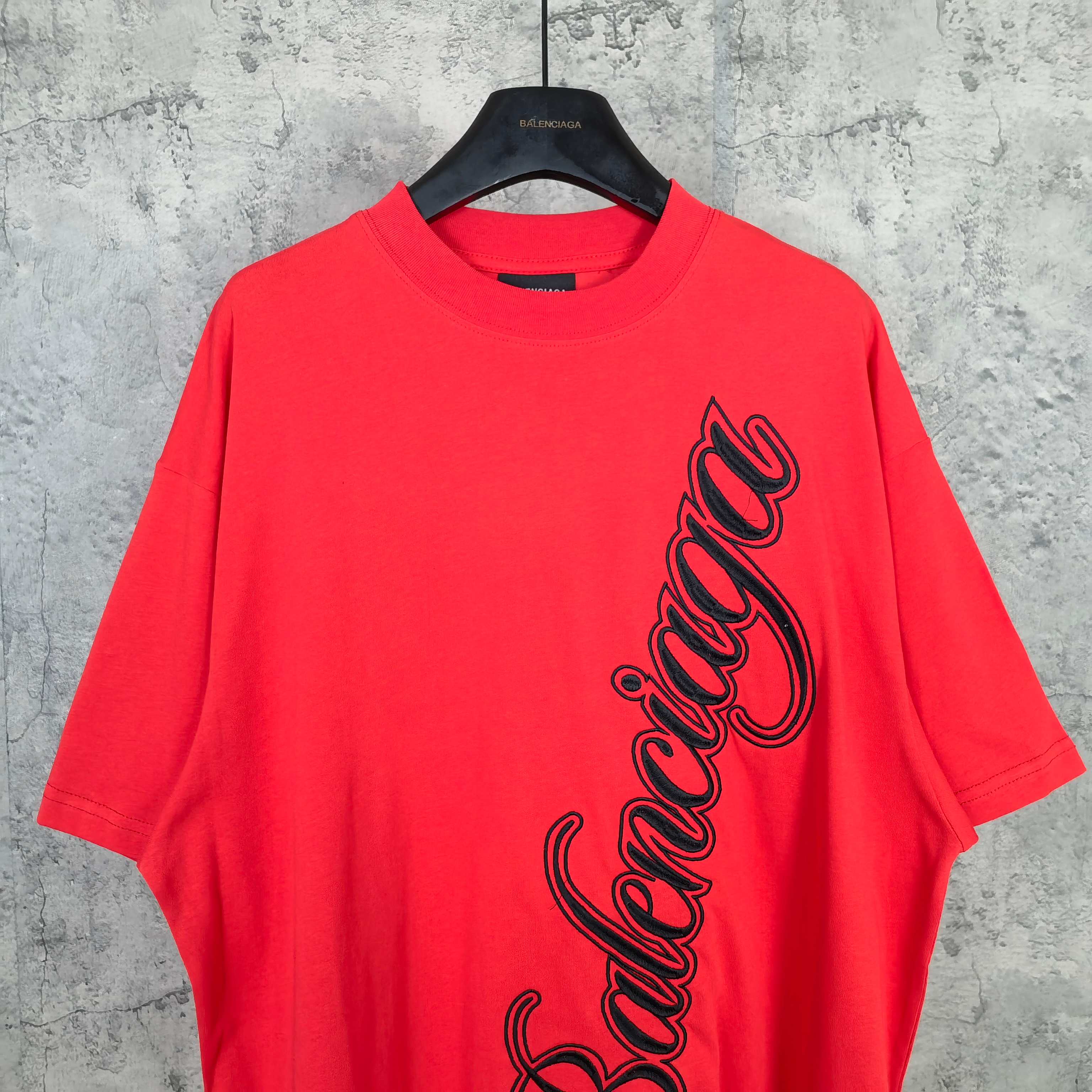 Balenciaga red short-sleeve T-shirt with black script logo on the front upper area