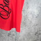 Balenciaga red short-sleeve T-shirt front hem with partial black script graphic