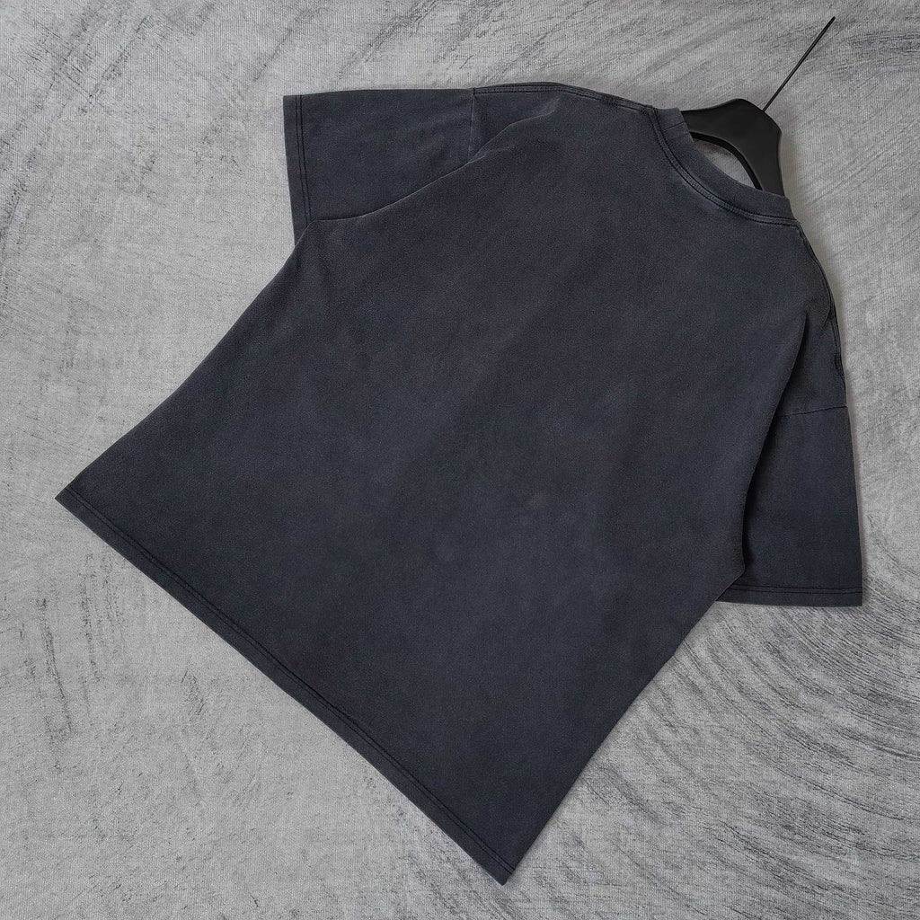 Dark wash T-shirt laid flat, crewneck and short sleeves visible