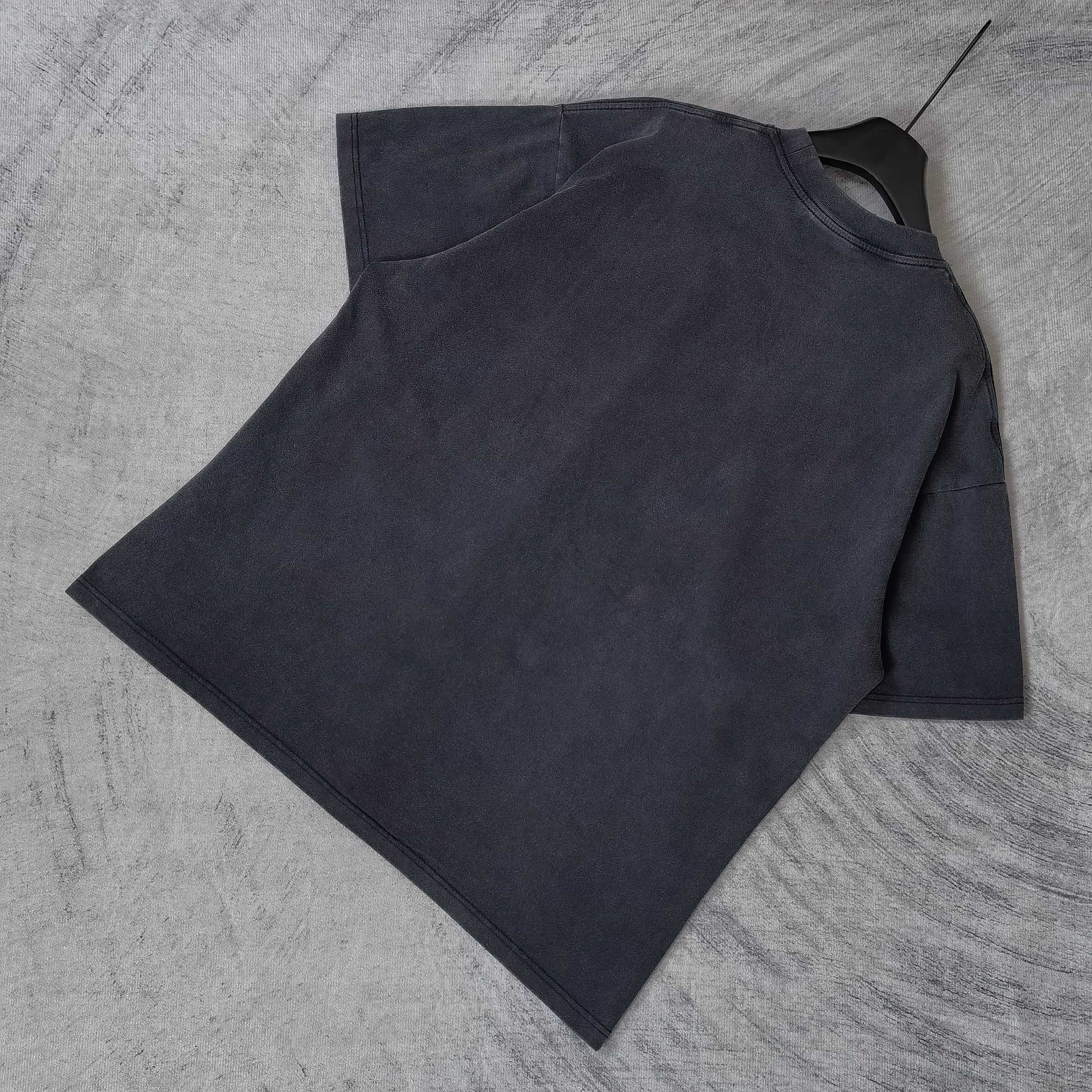 Dark wash T-shirt laid flat, crewneck and short sleeves visible