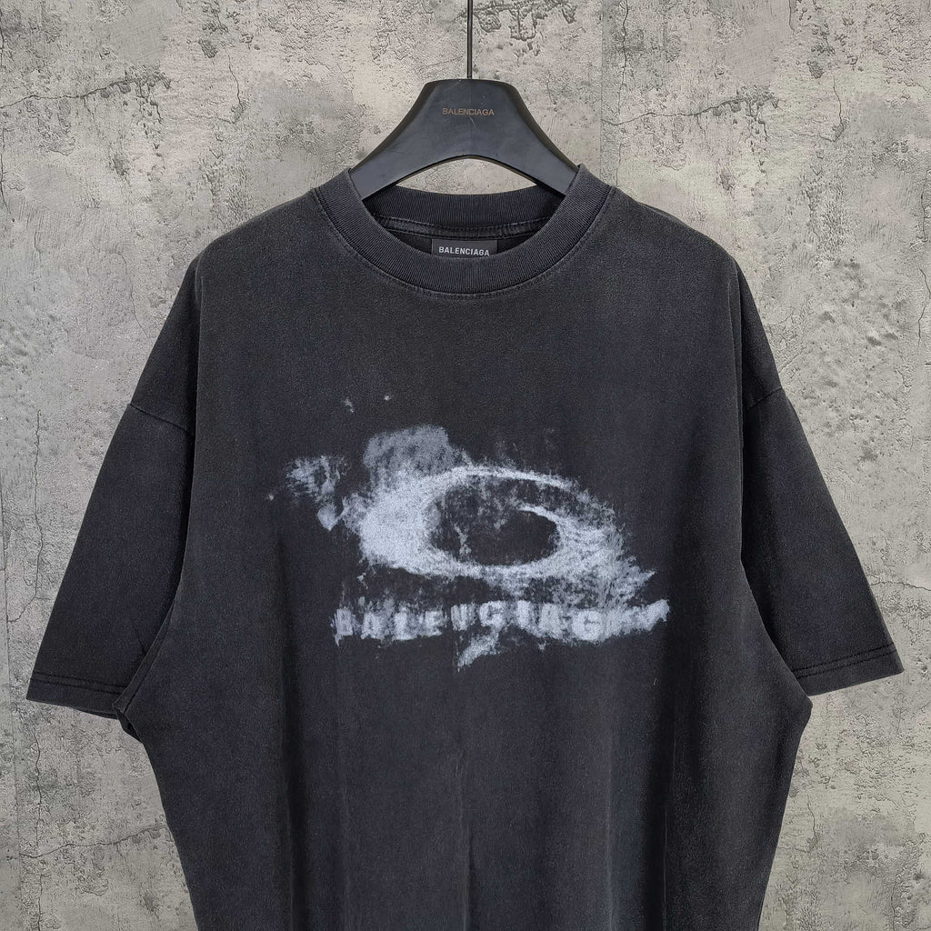 Dark wash T-shirt with large white eye graphic and distressed text