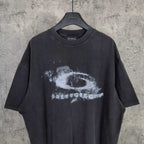 Dark wash T-shirt with large white eye graphic and distressed text
